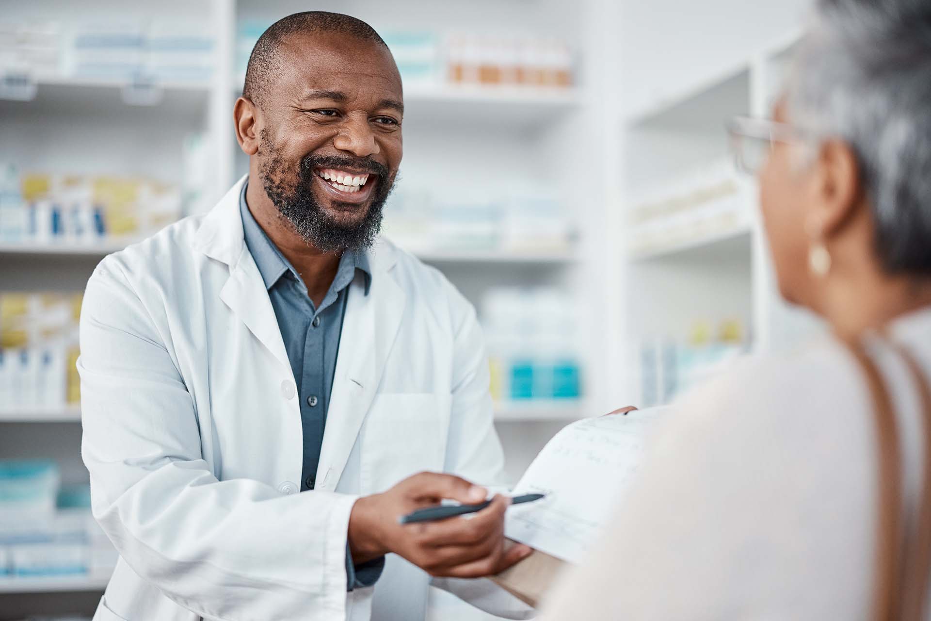 Happy Pharmacist Working with Customer | PharmCAP®